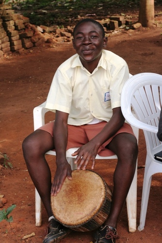 Young boy with a drum smiling