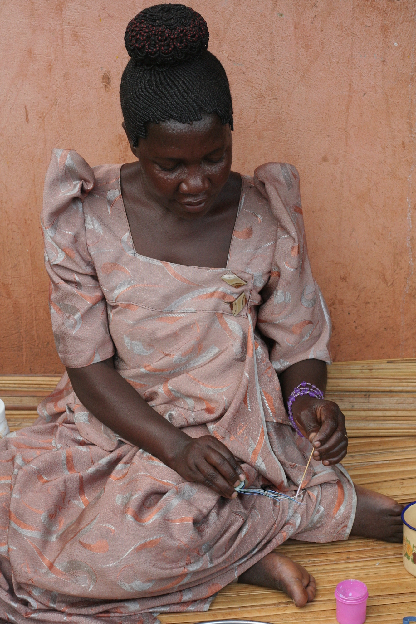 Woman making paper beads