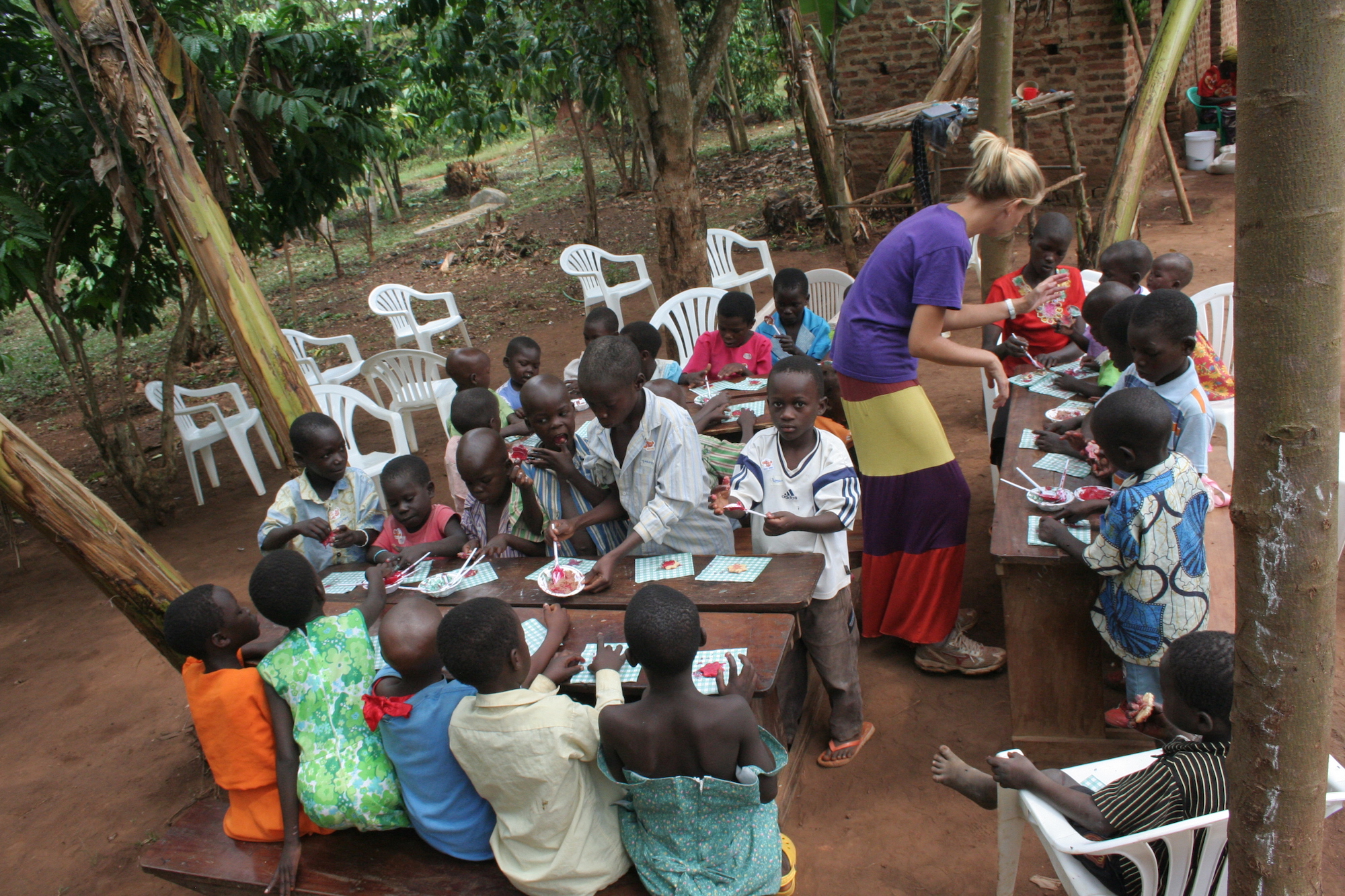 Woman standing amid tables of kids eating