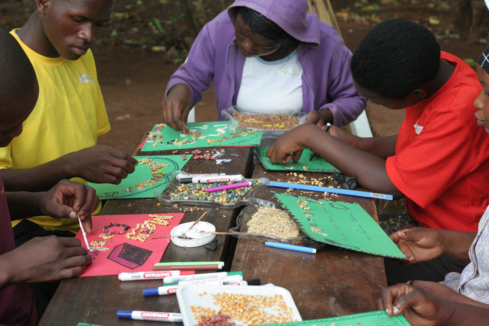 Young people at a table making Christmas cards