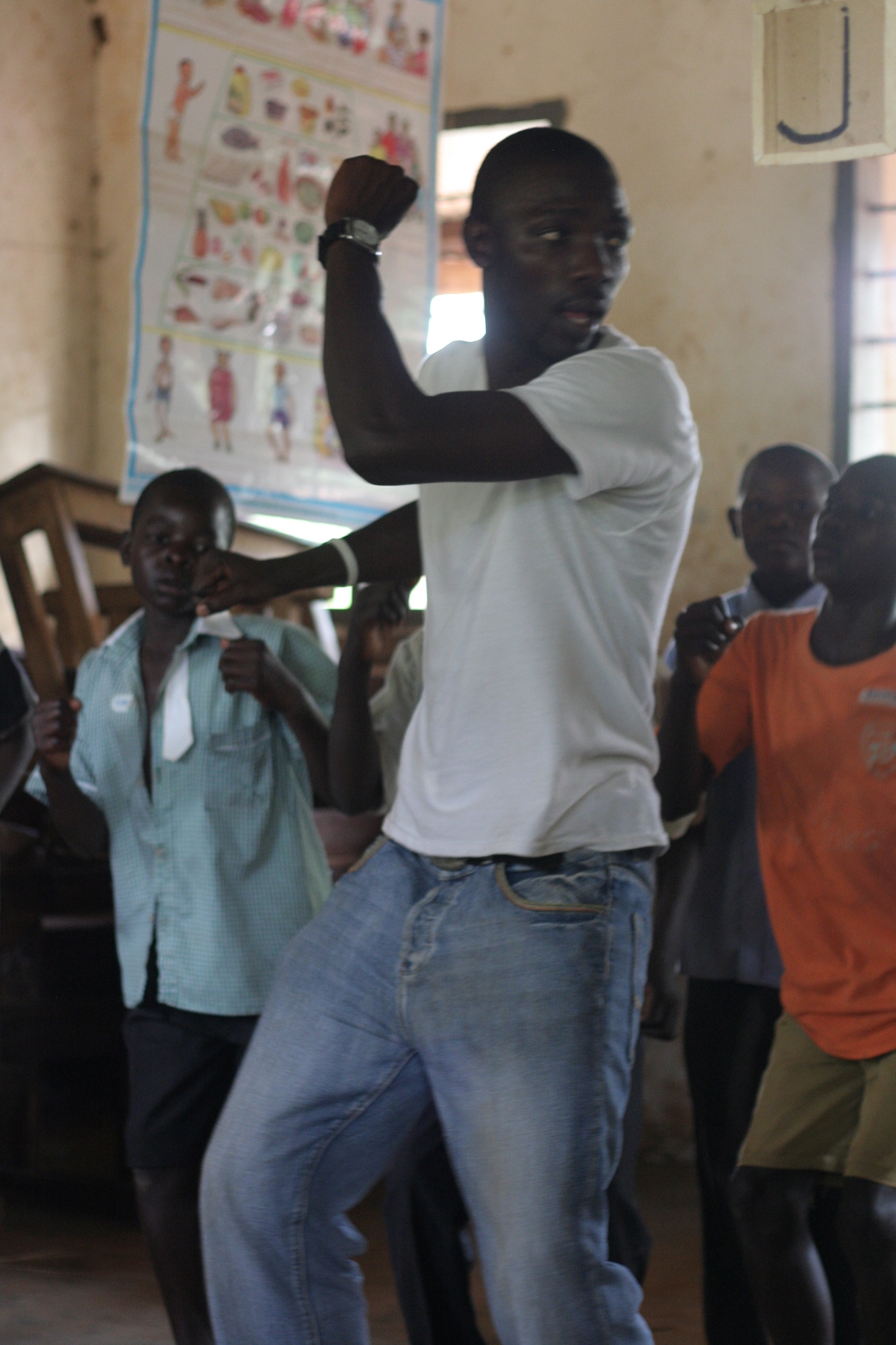 Man teaching kids a dance step