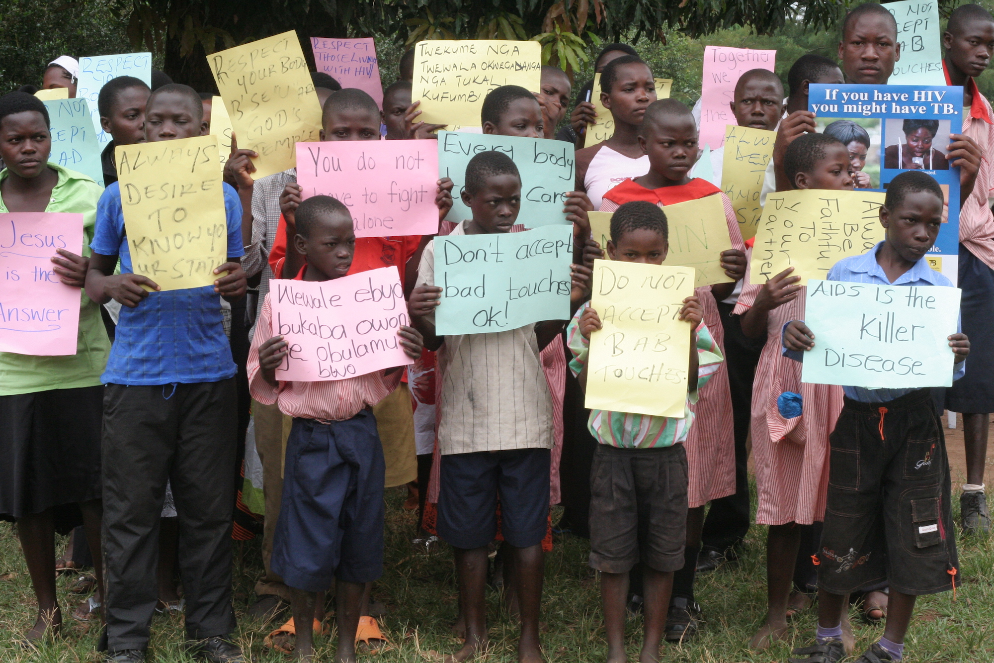 Group of young people holding handwritten signs
