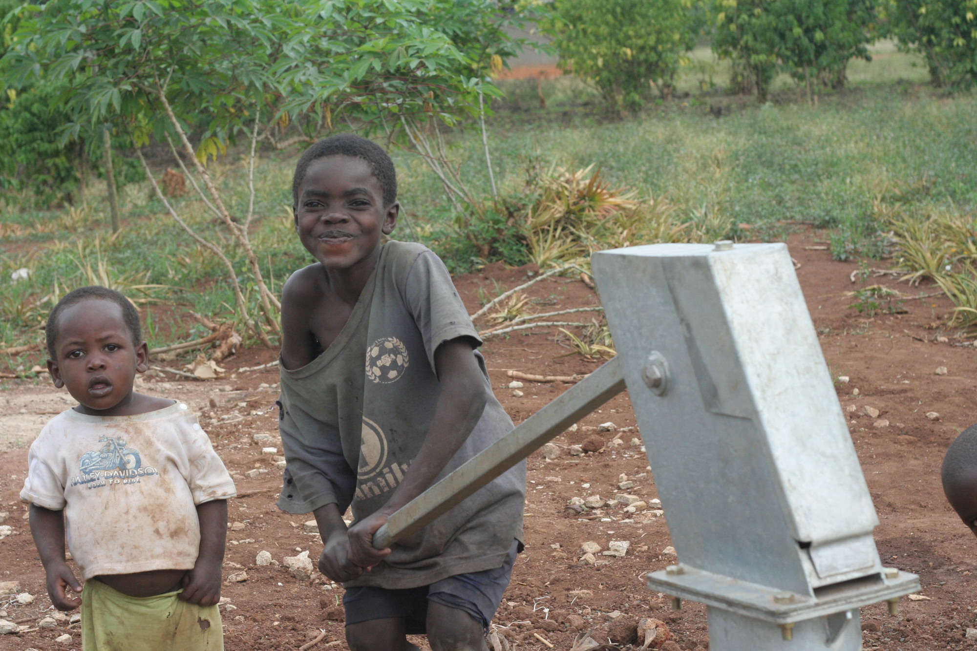 Smiling Child at a water pump