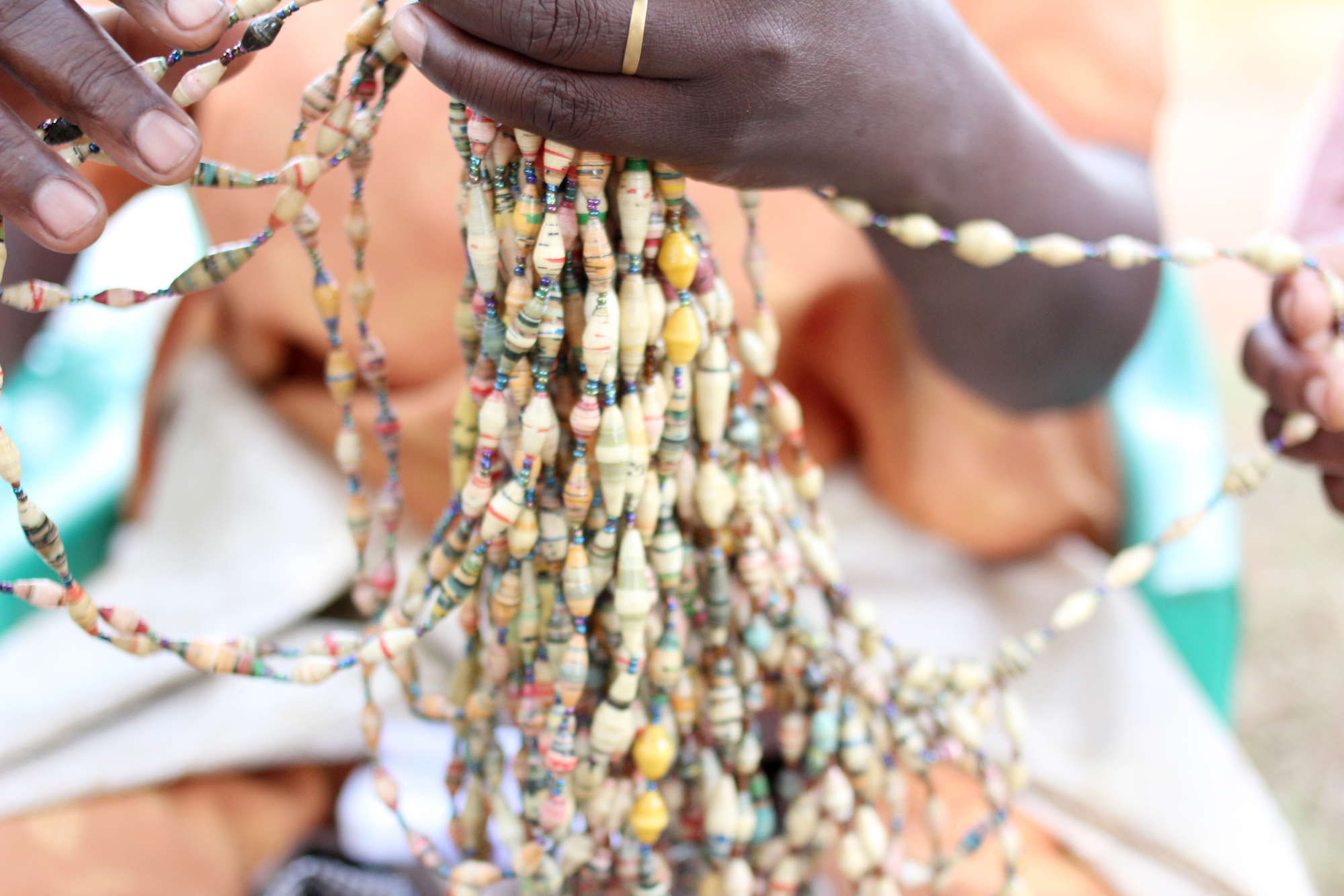 Close up of bead strands in a woman's hand