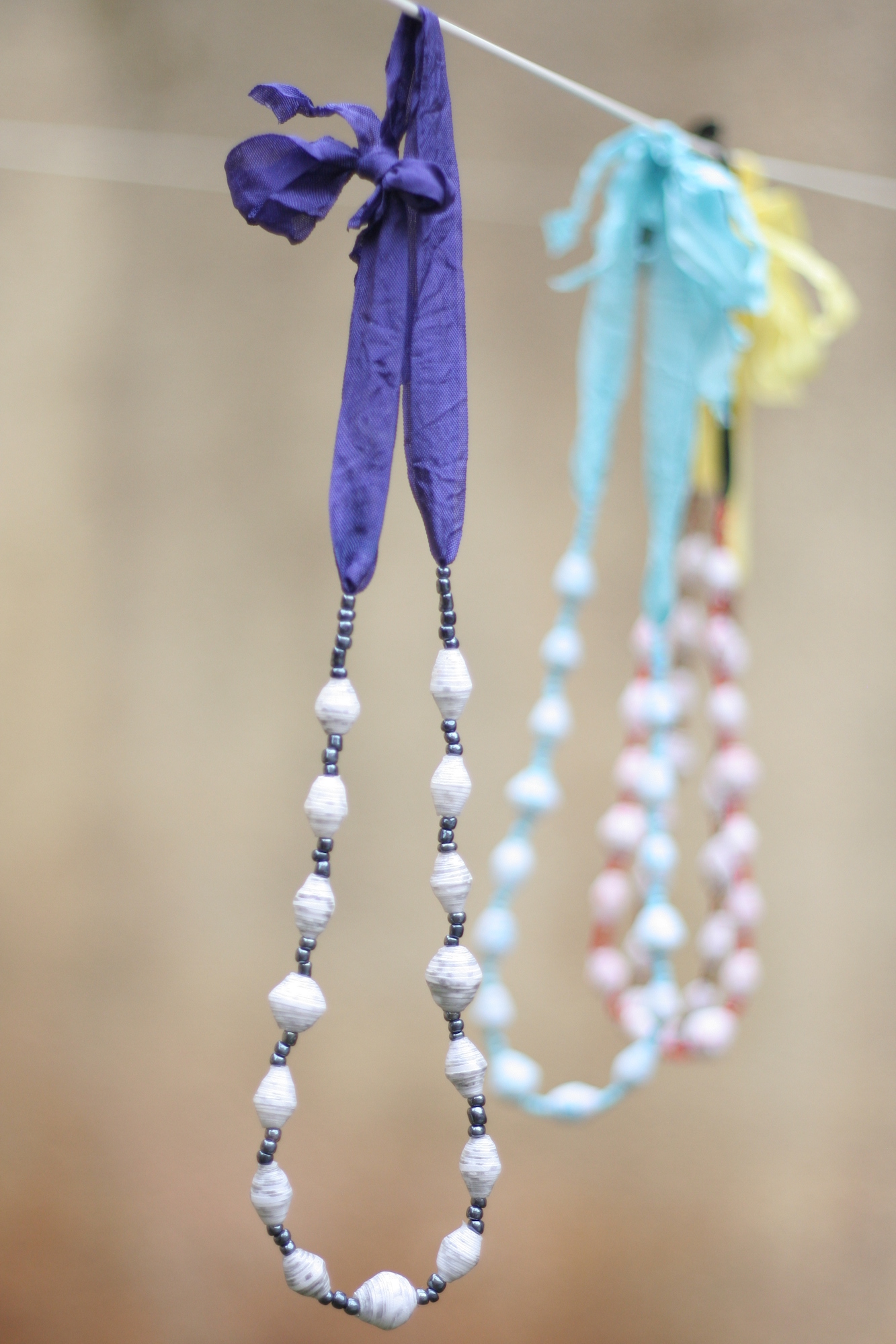 Beaded necklace, white beads on purple ribbon