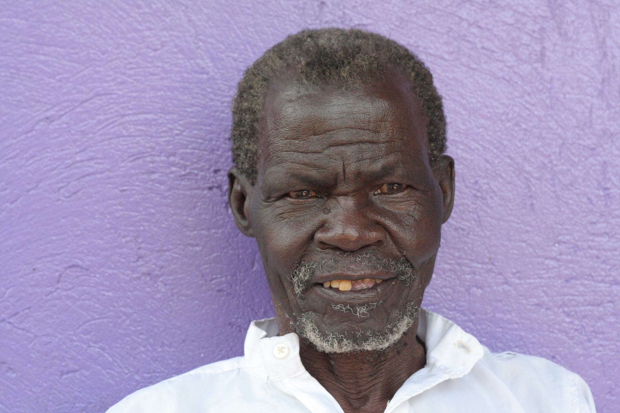 Man in front of a purple wall