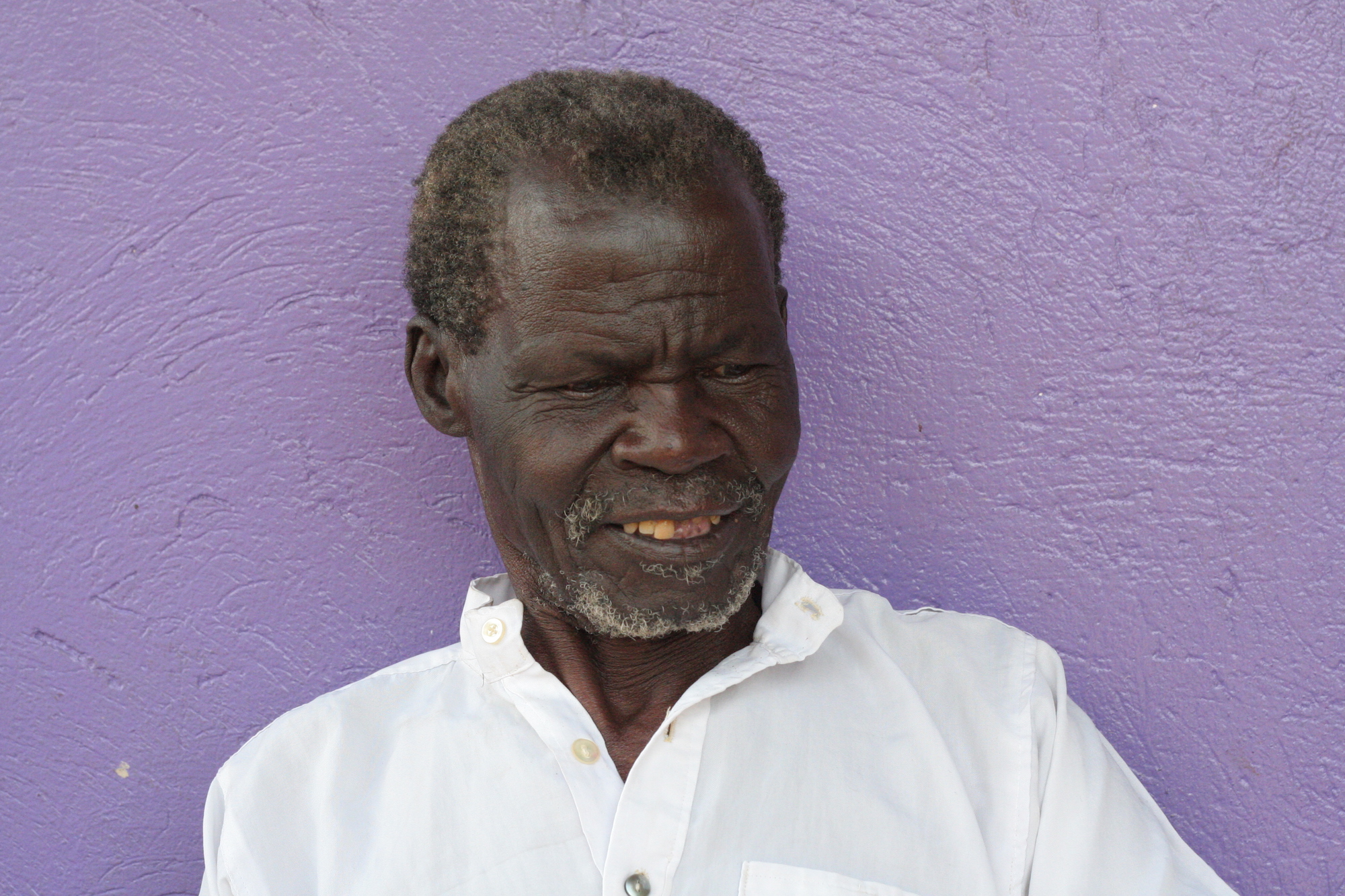 Man in front of a purple wall