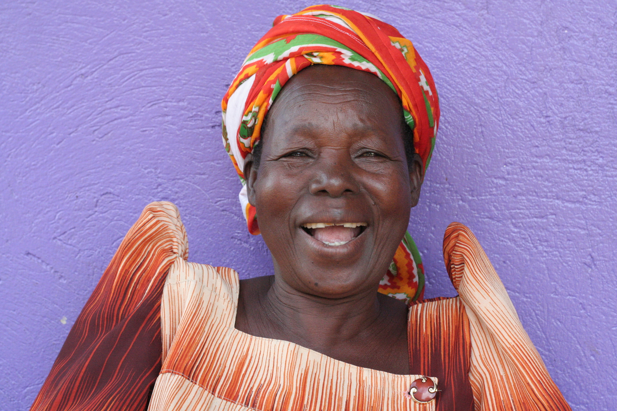 Laughing woman in front of a purple wall