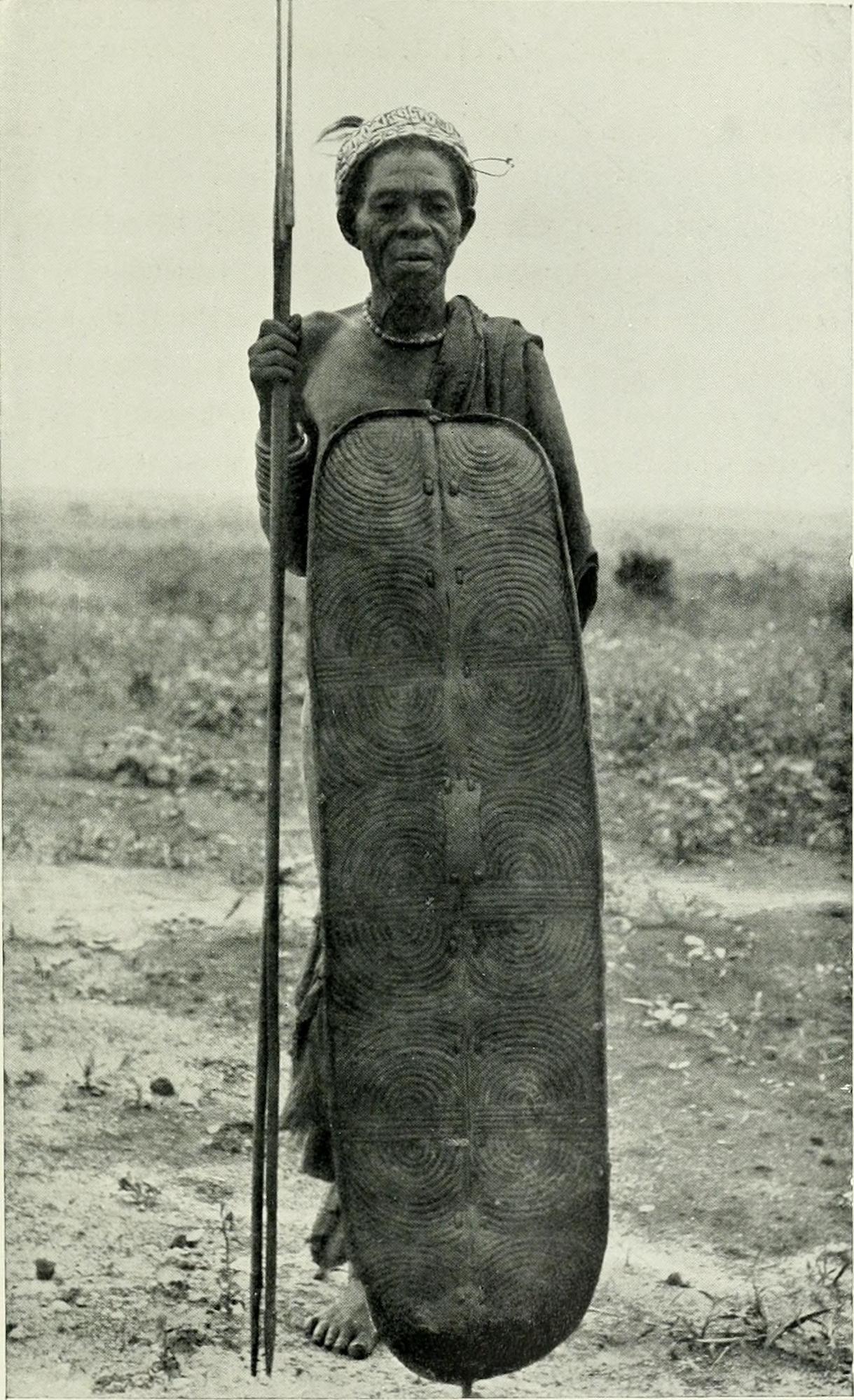 Black and white photo of man with shield and spear