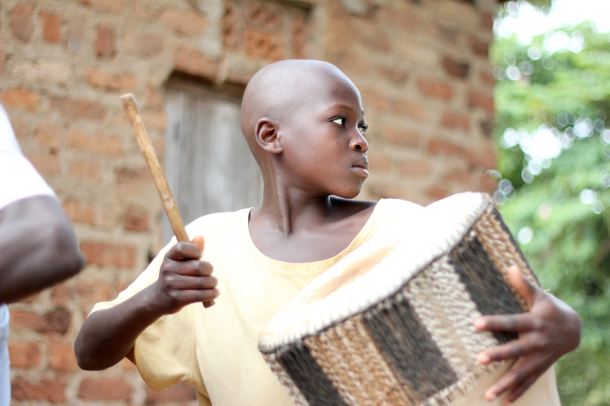 A young boy playing a drum