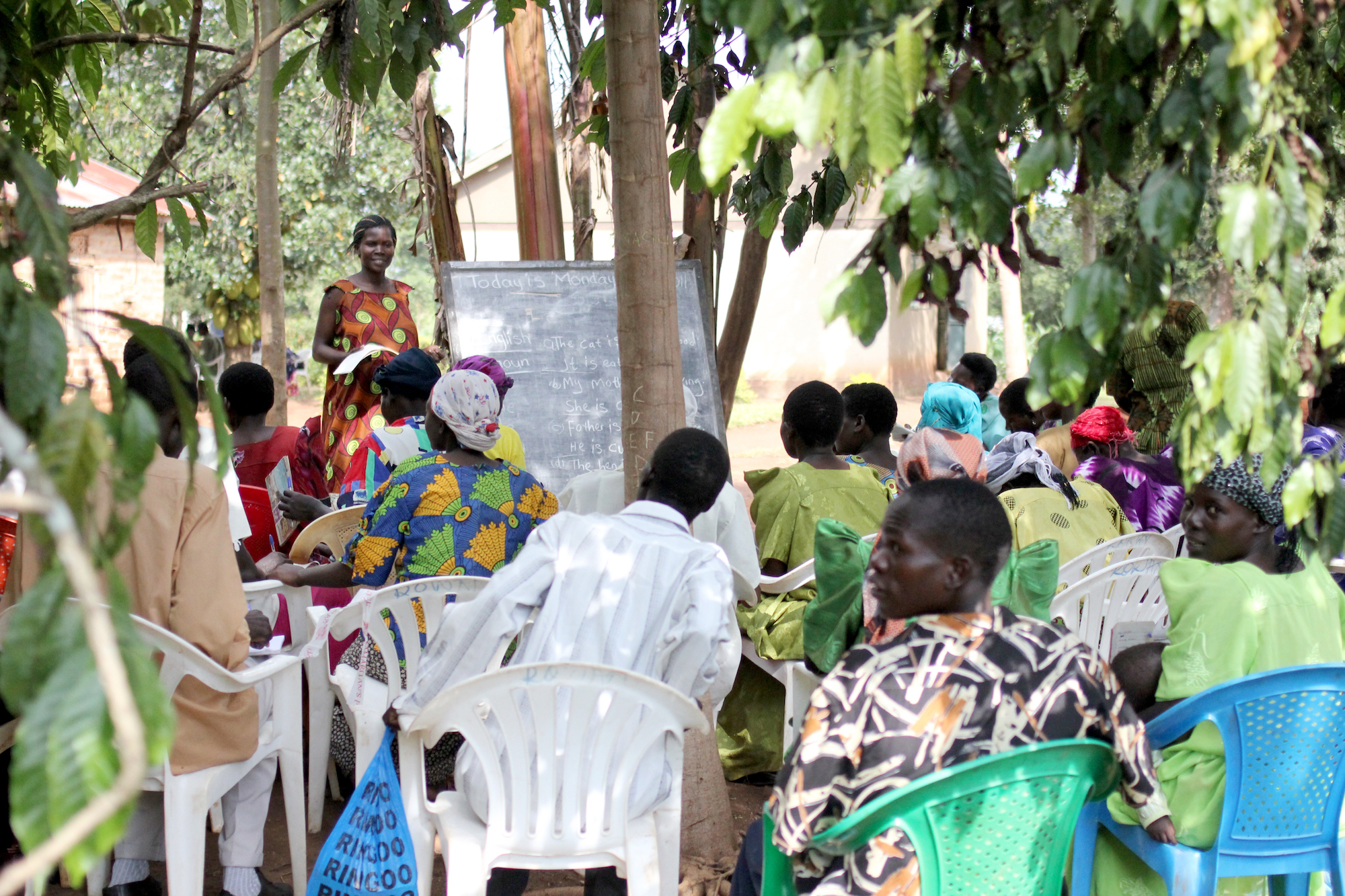A group of women learning in an outdoor classroom