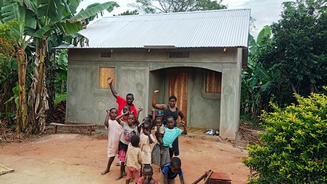 A ROWAN family in Uganda in front of the new home that was built for them.