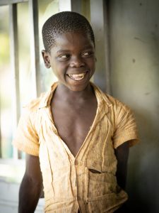 A young boy smiling in Uganda