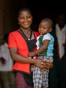 A woman holding a small child in Uganda