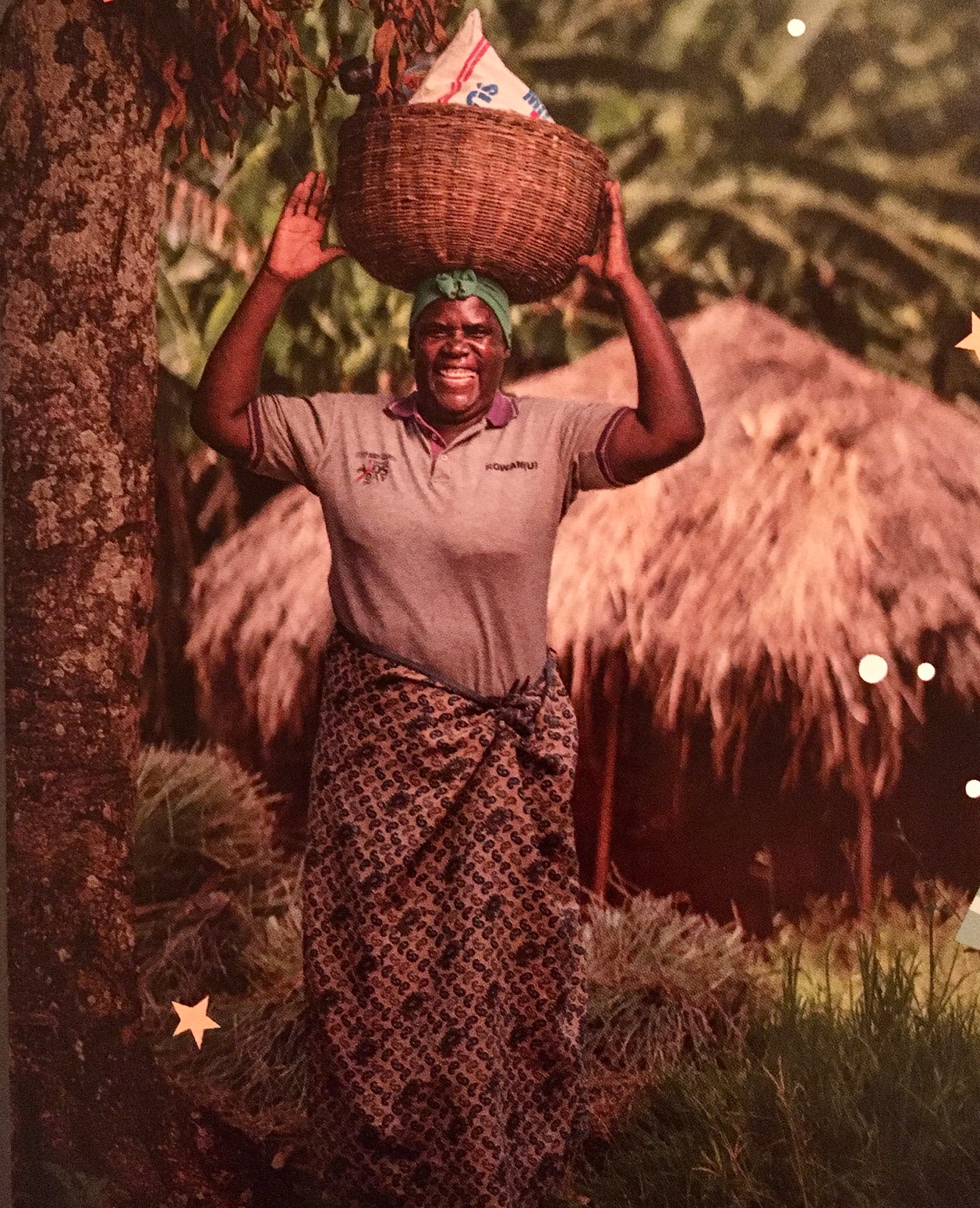 Woman in Uganda holding a basket of food on her head