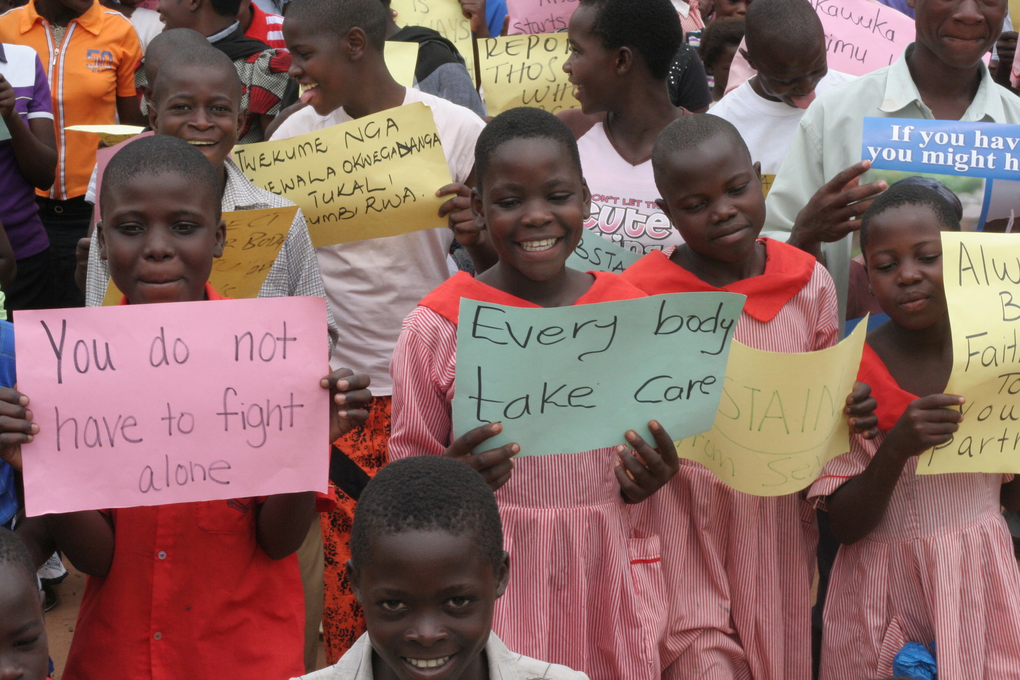  group of young people holding encouraging signs